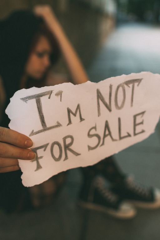 Woman holding bot for sale sign